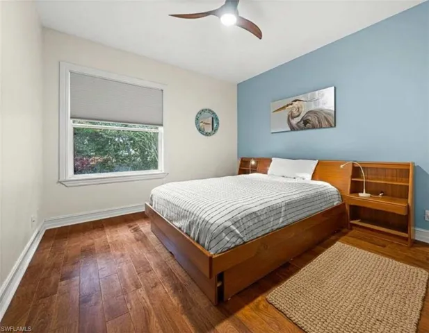 Bedroom with hardwood / wood-style floors and ceiling fan