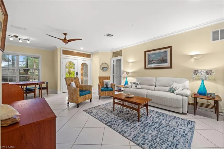 Living area featuring ornamental molding, light tile patterned floors, french doors, a ceiling fan, and recessed lighting