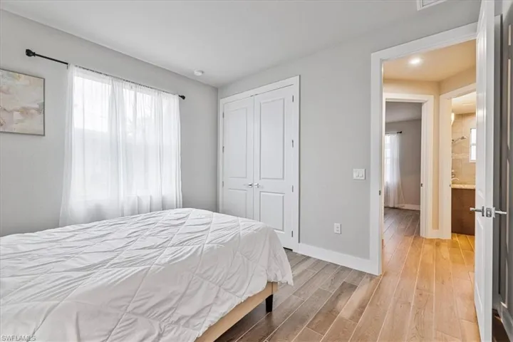 Bedroom with light wood-style floors and a closet