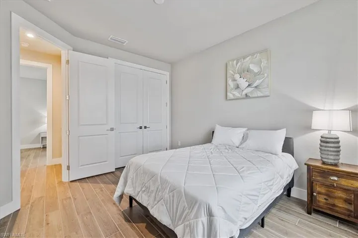 Bedroom featuring light wood-style flooring, a closet, and recessed lighting