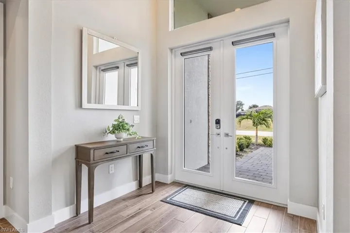 Foyer entrance featuring wood finished floors and french doors