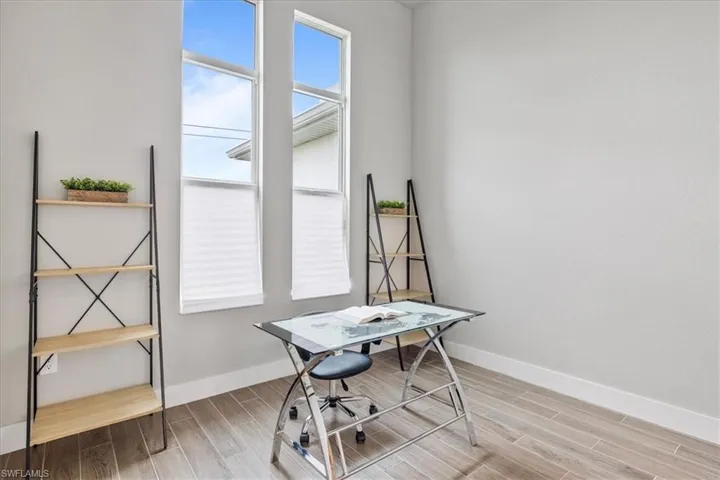 Office area with baseboards and light wood finished floors