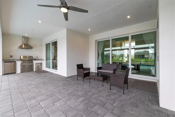 View of patio with exterior kitchen and a ceiling fan
