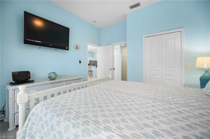 Vaulted ceiling, ceiling-mounted television, bi-fold closet doors, and recessed lighting