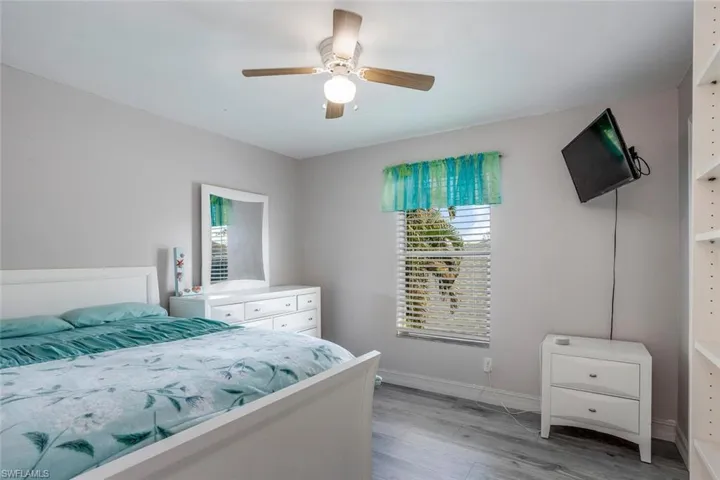 Bedroom with light wood-type flooring and a ceiling fan