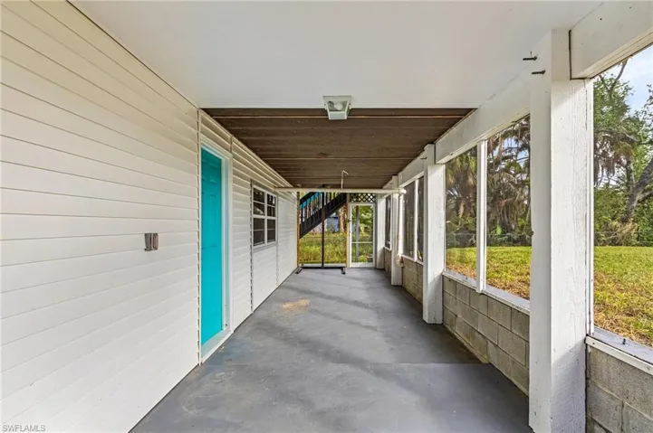 Downstairs screen porch with grilling area.