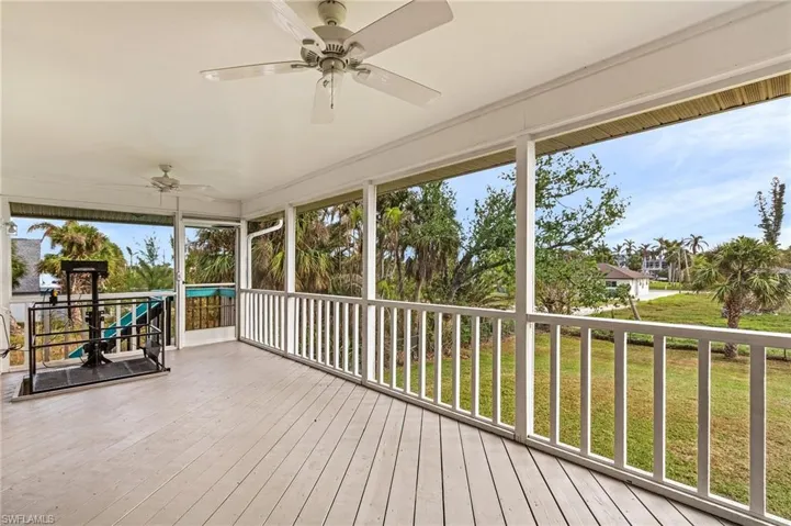 Screen porch has a lift making the home handicap accessible.