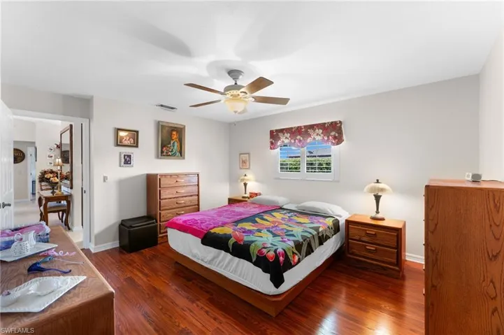 Master Bedroom with dark wood-type flooring and ceiling fan