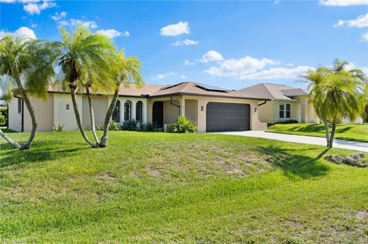 Ranch-style home with a garage and a front yard