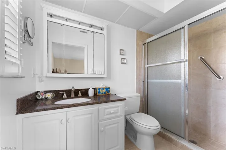 Master Bathroom featuring walk in shower, vanity, toilet, and tile floors