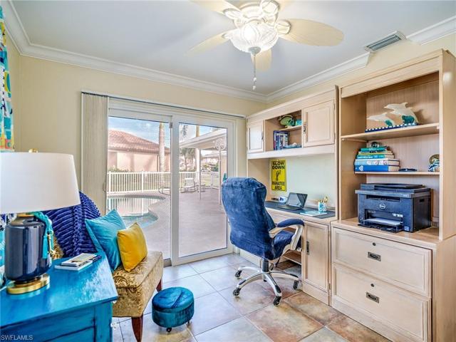 Bedroom #4, set up as an office.  View out to the pool.
