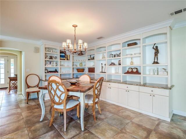 Informal dining room or den.  Built in cabinets all have slide-out shelves.