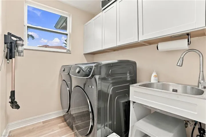1st Floor Laundry with Full size Samsun Washer and Dryer- Cabinetry and utilty Sink