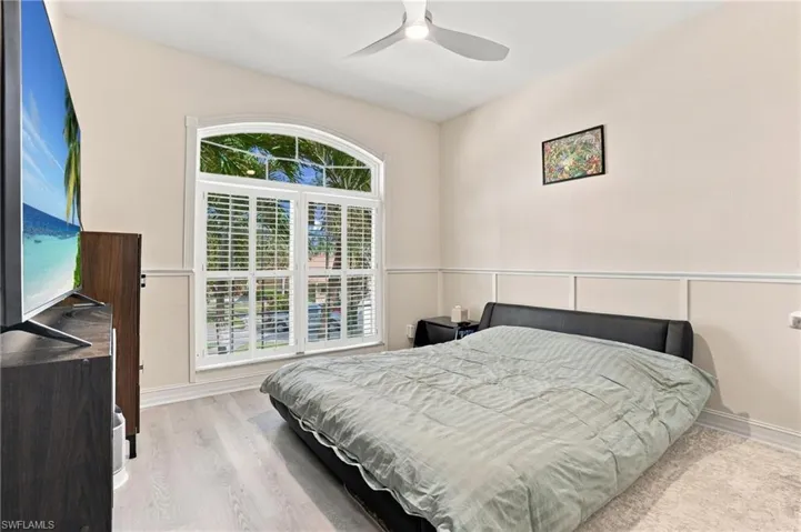 Bedroom 2 with Bi-Fold closet, arched window and plantation shutters.
