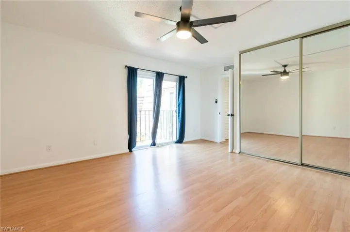 Unfurnished bedroom with access to exterior, a closet, ceiling fan, light wood-style flooring, and a textured ceiling