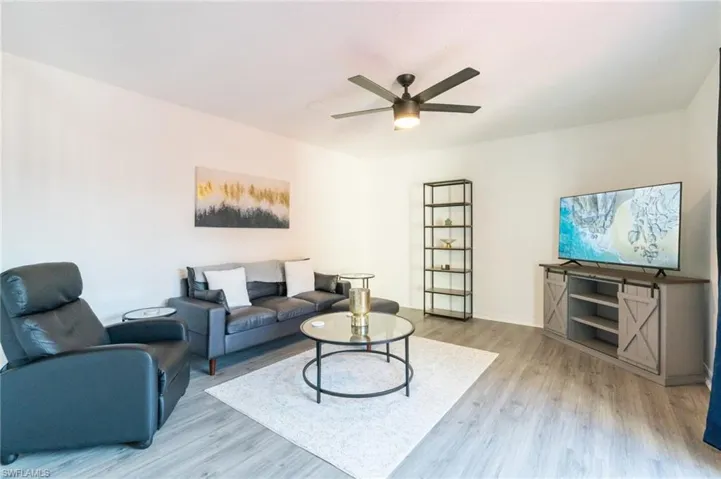 Living area featuring light wood-style flooring and a ceiling fan