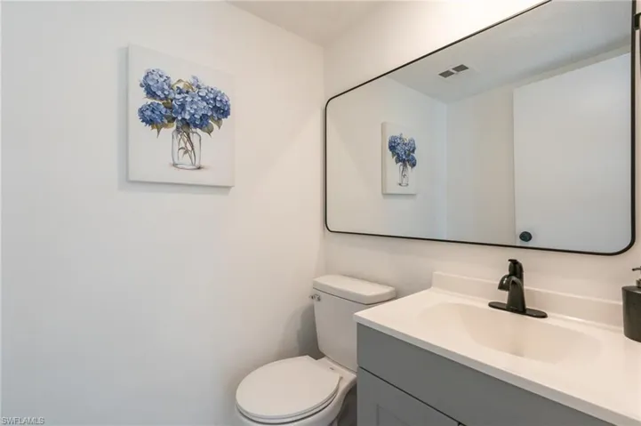 Bathroom featuring vanity and toilet