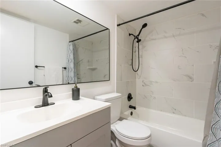 Full bathroom with shower / tub combo and vanity