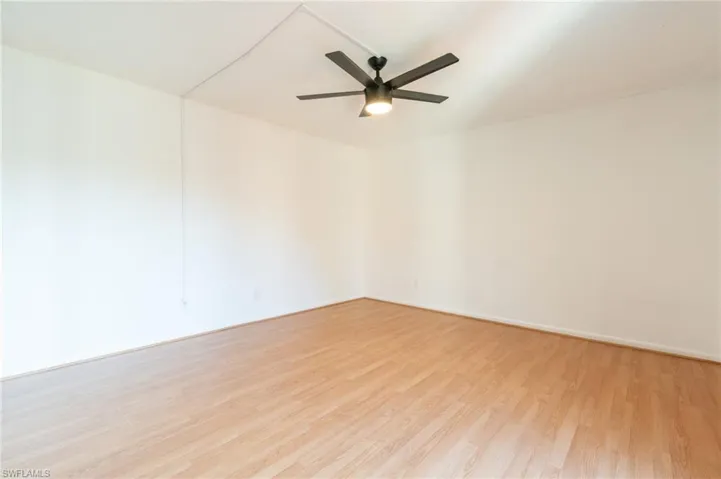 Unfurnished room with light wood-type flooring and a ceiling fan