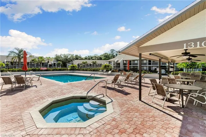 View of pool with a community hot tub, a patio, and ceiling fan