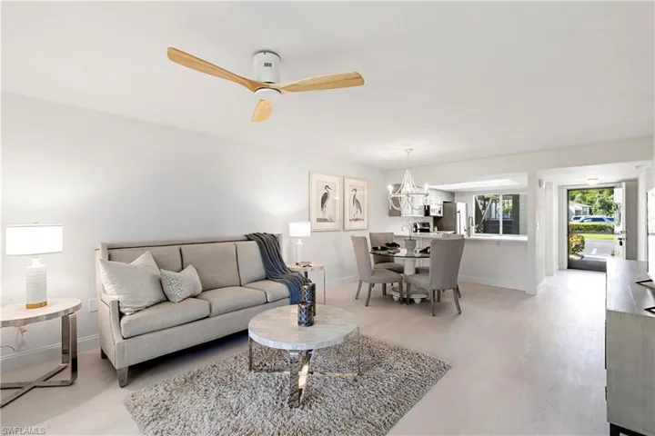 Living room with ceiling fan and light wood-type flooring