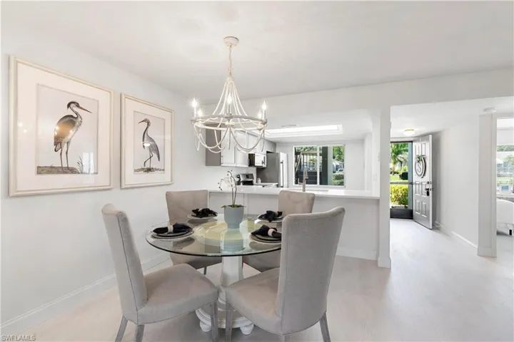 Dining area with a chandelier and light hardwood / wood-style flooring