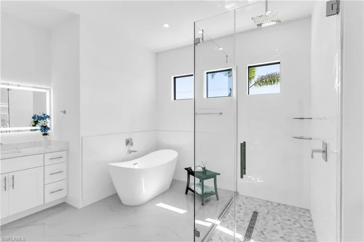 Bathroom featuring vanity and plus walk in shower