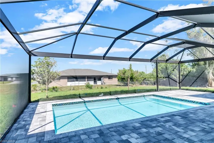View of swimming pool with a patio area and a lanai