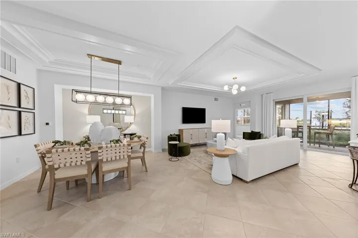Living area with a chandelier and a raised ceiling