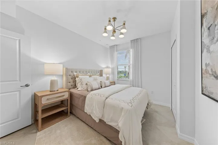 Bedroom featuring a chandelier and light tile patterned floors