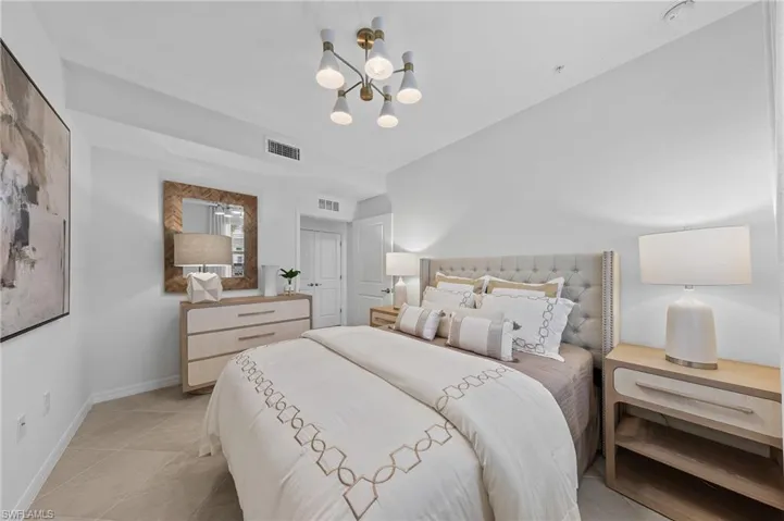 Bedroom featuring a chandelier and light tile patterned floors