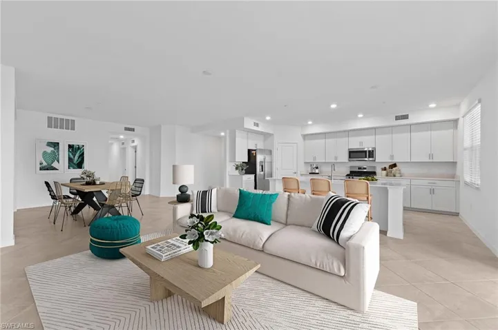 Living area with recessed lighting and light tile patterned flooring