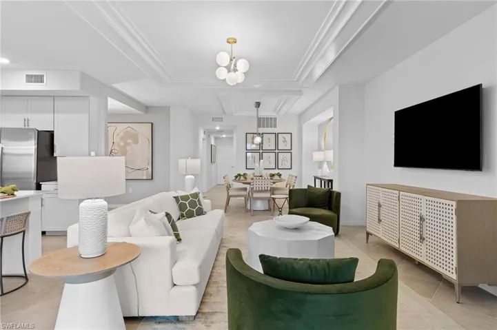 Living area featuring light tile patterned floors and a chandelier