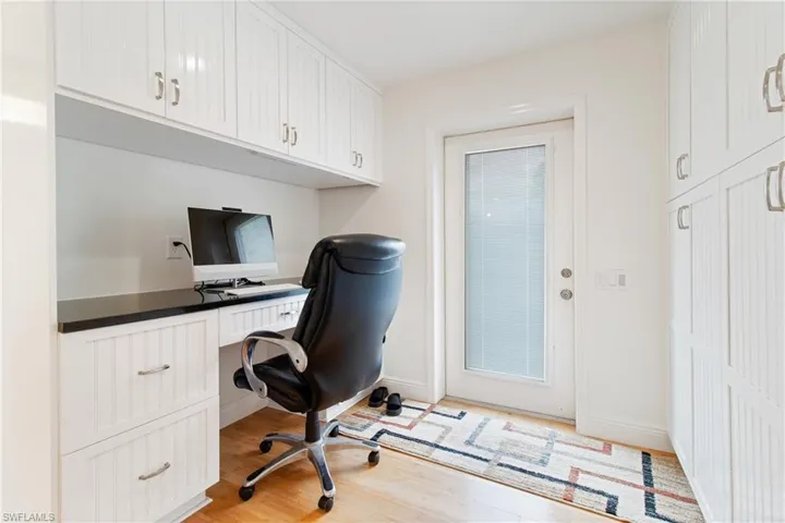 Office with light hardwood / wood-style floors