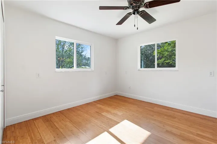 Empty room with light hardwood / wood-style flooring and ceiling fan
