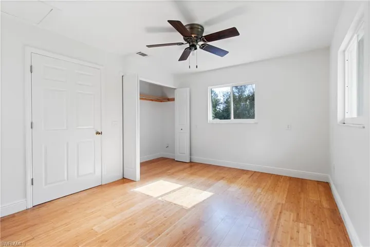 Unfurnished bedroom with light wood-type flooring and ceiling fan