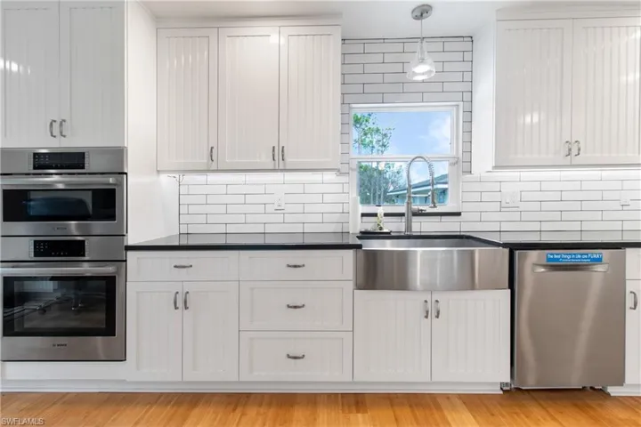 Kitchen with white cabinets, sink, and appliances with stainless steel finishes
