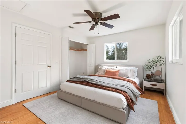 Bedroom featuring wood-type flooring and ceiling fan