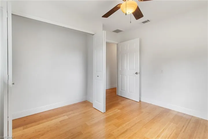 Spare room with light wood-type flooring and ceiling fan