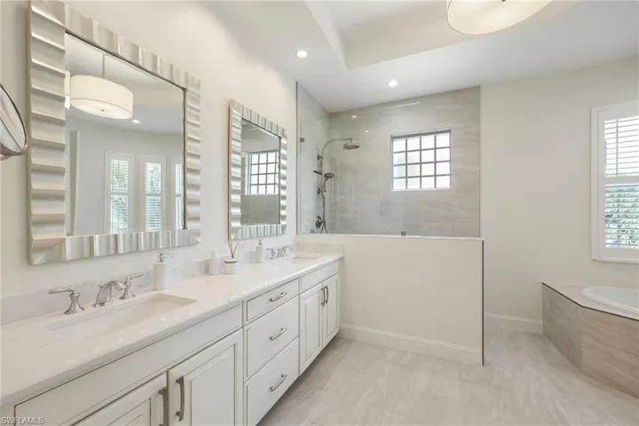 Ensuite with dual sinks, walk-in shower, soaking tub and water closet