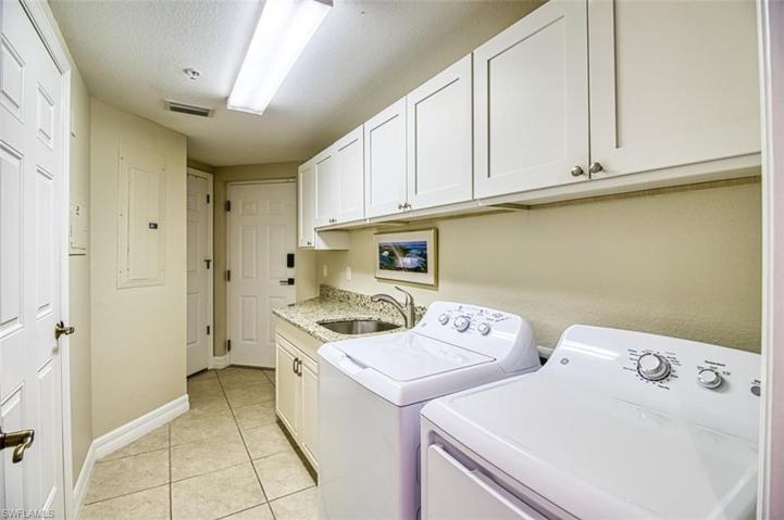 Laundry has sink and cabinets