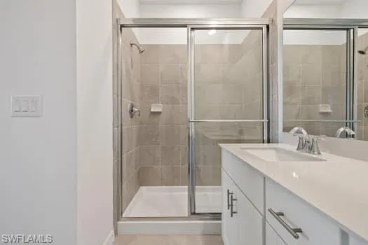 Bathroom featuring vanity and a shower stall