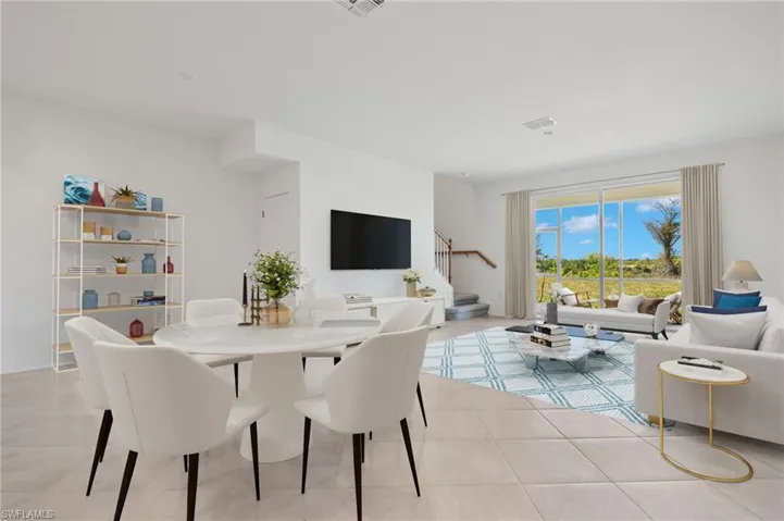 Dining area with stairs and light tile patterned floors