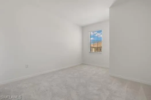 Unfurnished room with carpet flooring and baseboards