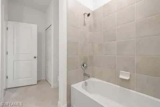 Full bathroom featuring shower / bathtub combination and baseboards