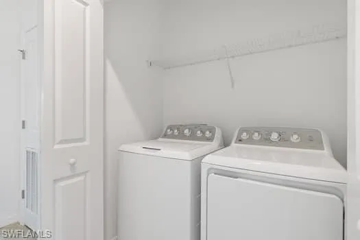 Washroom featuring washing machine and dryer