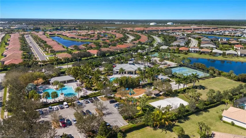 Aerial view of property and surrounding area featuring nearby suburban area