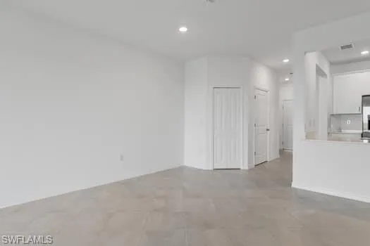 Unfurnished living room featuring recessed lighting