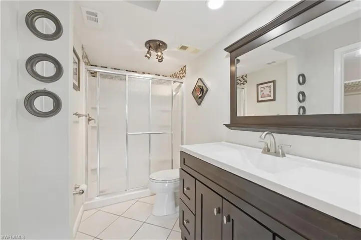 Master Bathroom with vanity, light tile patterned floors, and a shower stall