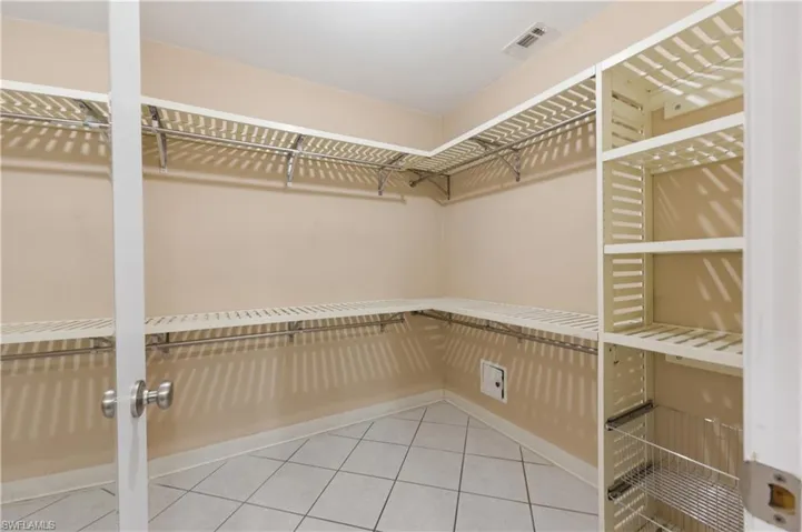 Walk in closet featuring light tile patterned flooring